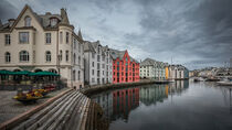 Colorful houses and waterway with boats in the city Alesund in Norway by Bastian Linder