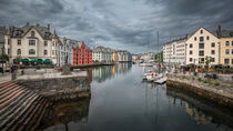Colorful houses and waterway with boats in the city Alesund in Norway by Bastian Linder