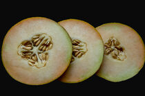 Melone in Scheiben auf schwarzem Hintergrund by Marlise Gaudig