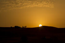 Sunset in desert with jeeps by Werner Roelandt