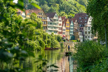 Traditional punt boat (Stocherkahn) on the Neckar River in front of the old town of Tübingen, Germany by caladoart