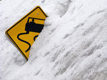 Slippery Road Sign in the Snowbank by Ed Book