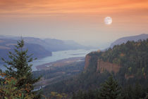 The moon hangs in the sky above the Vista House, Oregon by Danita Delimont