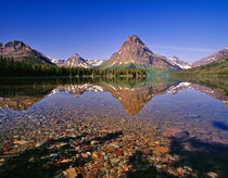 Mountains reflect into calm Two Medicine Lake in Glacier National Park, Montana von Danita Delimont