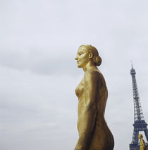 Gilded statue of a woman with a tower in the background by Panoramic Images