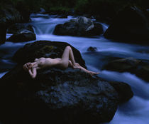 High angle view of a teenage girl lying naked on a rock von Panoramic Images