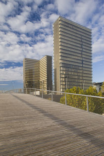 Footbridge with buildings in the background by Panoramic Images