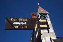 Low angle view of street signs with a church by Panoramic Images