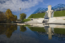 Reflection of a stadium in a pond by Panoramic Images