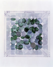 Pebbles in a horizontal clear glass box by Panoramic Images