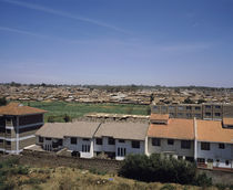 Houses with shanty town in the background, Kibera, Nairobi, Kenya by Panoramic Images