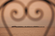 Small island viewed through heart shaped pattern by Panoramic Images