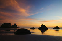 Sunset sky silhouetted sea stacks on Bandon Beach Bandon Beach State Park by Panoramic Images