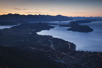 High angle view of a coastal town lit up at dusk von Panoramic Images