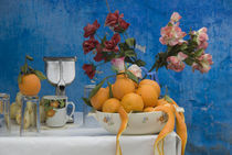 Close up of colorful juice stand with flowers and oranges by Panoramic Images