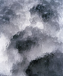 Close up of dark grey light grey and white wispy stained glass by Panoramic Images