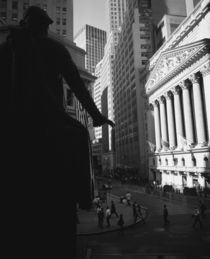 Silhouette of George Washington statue in front of a financial building by Panoramic Images