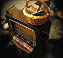 High angle view of a wicker basket on an antique radio set, France von Panoramic Images