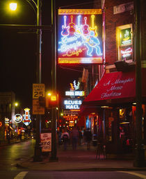 Neon sign lit up at night in a city by Panoramic Images