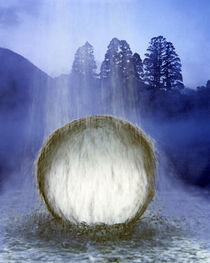 Water cascading over crystal sphere with silhouette of trees in background by Panoramic Images