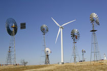 Traditional windmills with a wind turbine on a landscape by Panoramic Images