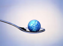 Small cloud filled globe resting in bowl of silver spoon von Panoramic Images
