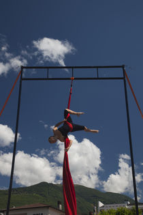 Acrobat street performer performing with textile by Panoramic Images