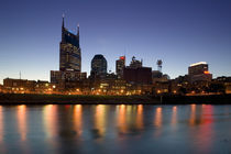 Buildings lit up at dusk at the waterfront by Panoramic Images
