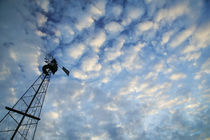 Low angle view of clouds over silhouetted windmill, Iowa, USA. von Panoramic Images