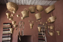 Wicker baskets and dreamcatchers hanging in a restaurant by Panoramic Images