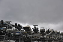 Motor Boats on racks at harbor by stormy sky von Sami Sarkis Photography