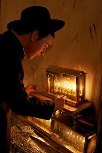 Jerusalem, lighting Hanukkah candles by Hanan Isachar