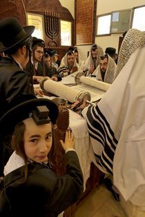 Purim holiday, the Rabbi is reading the Torah by Hanan Isachar