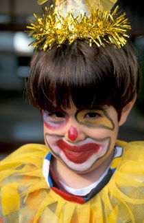 A boy with a clown costume on Purim holiday by Hanan Isachar