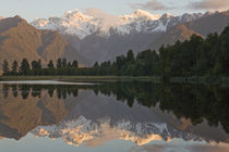 Reflective view across Lake Matheson of the Southern Alps