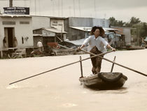 Vietnamese woman rowing a boat in Mekong River in Vietnam by dreamyfaces