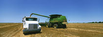 Combine in a wheat field, Kearney County, Nebraska, USA by Panoramic Images