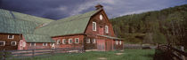 Old red barn with green rooftops in a farm, Vermont, USA by Panoramic Images