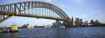 Australia, New South Wales, Sydney, Sydney harbor, View of bridge and city by Panoramic Images