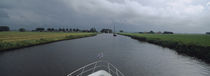 Motorboat in a canal, Friesland, Netherlands by Panoramic Images