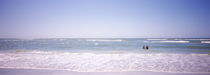 Couple standing in water on the beach, Gulf of Mexico, Florida, USA by Panoramic Images