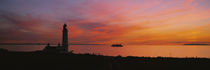 Silhouette of a lighthouse at sunset, Scotland von Panoramic Images