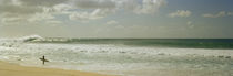 Surfer standing on the beach, North Shore, Oahu, Hawaii, USA by Panoramic Images
