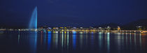 Buildings lit up at night, Jet D'eau, Lake Geneva, Lausanne, Switzerland by Panoramic Images