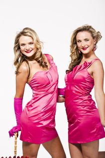 Blonde twins in pink dresses by vito vampatella