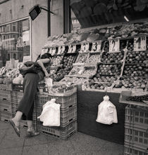 Woman and produce stand: Berlin by Ron Greer