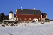 Red barn with snow covered field. by John Greim