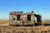 Abondoned shack with American flag by John Greim