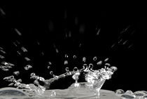 Drop of water splashing, close up by Sami Sarkis Photography