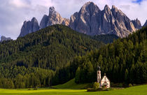 Beautiful isolated lonely church called Rainui in valley in the Italian Dolomites village of Val Di Funes mountains Alpine area of Italy with Dolomites looming behind by Danita Delimont